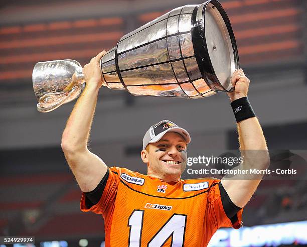 The BC Lions quarterback Travis Lulay raises the Grey Cup after the Lions defeated the Winnipeg Blue Bombers 34-23 at the Canadian Football League...