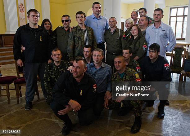 Euromaidan self-defence activists make group picture with Ukraine's burly boxing hero and strident protest leader Vitali Klitschko inside the Kiev...