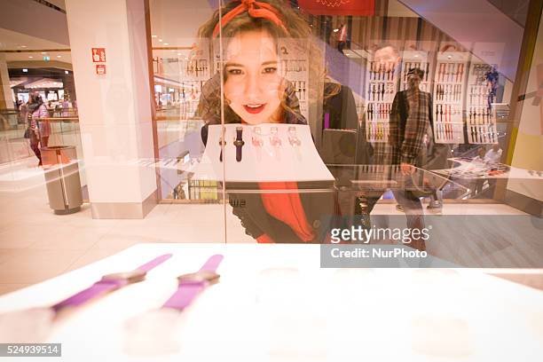 Woman is seen looking at watches in the newly opened Zielony Arkady mall on Friday. The recently elected government set up a proposal for shopping...