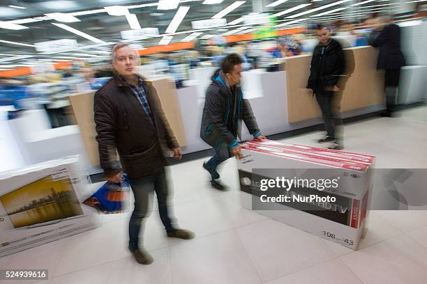 People can be seen buying tv's a the newly opened Saturn electronics store in the Zielony Arkady mall on Friday. The recently elected government set...