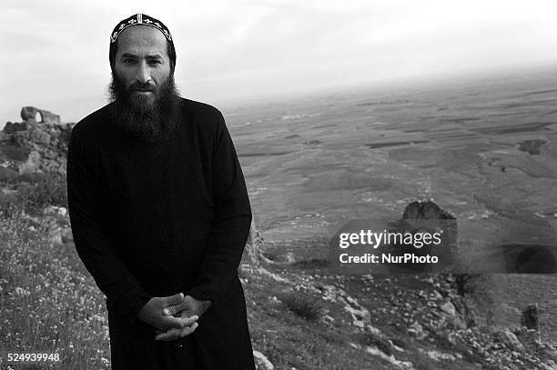 Father Joaqim stands by Mor Augen Monastery, overlooking Syria and the Mesopatamian plain .Mor Augen is an ancient Syriac Orthodox Monastery,...