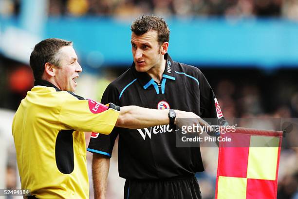 Glen Little of Reading talks to an assistant referee during the Coca Cola Championship match between Queens Park Rangers and Reading at Loftus Road...