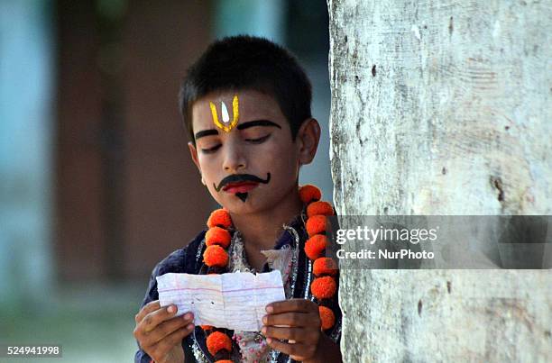 An Indian artist,dressed as a character prepares for his dialogues, brfore traditional Ramleela,a play narrating the life of Hindu God Ram,ahead of...