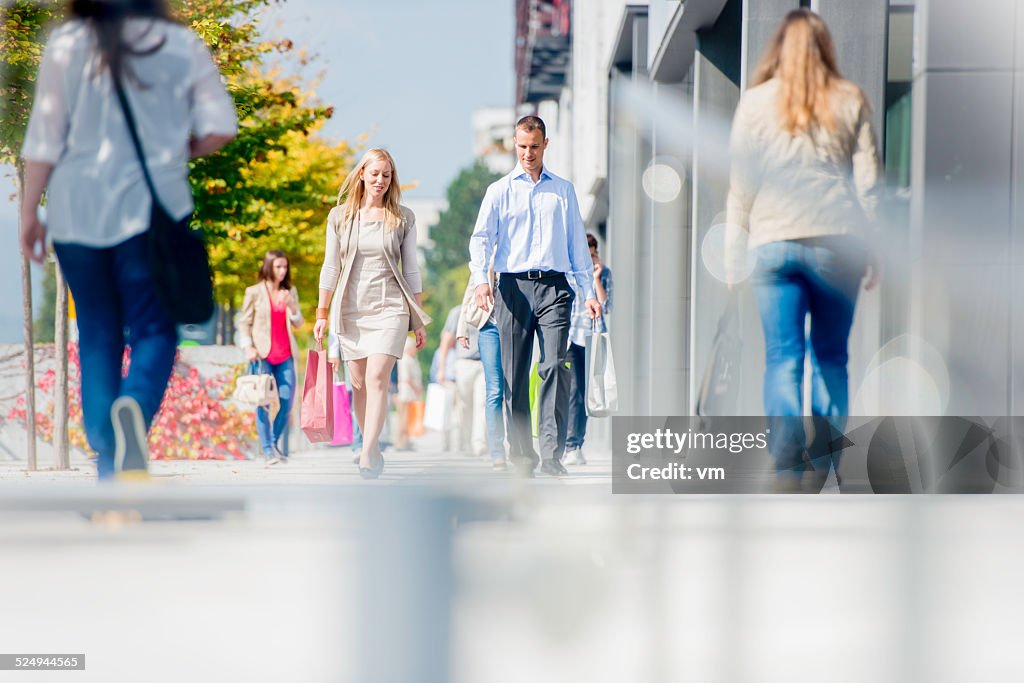 Couple on Crowded City Street After Shopping