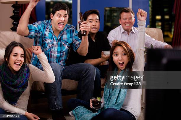 multi-ethnic young adult friends hanging out, downtown apartment. watch tv. - media entertainment night 2014 stock pictures, royalty-free photos & images