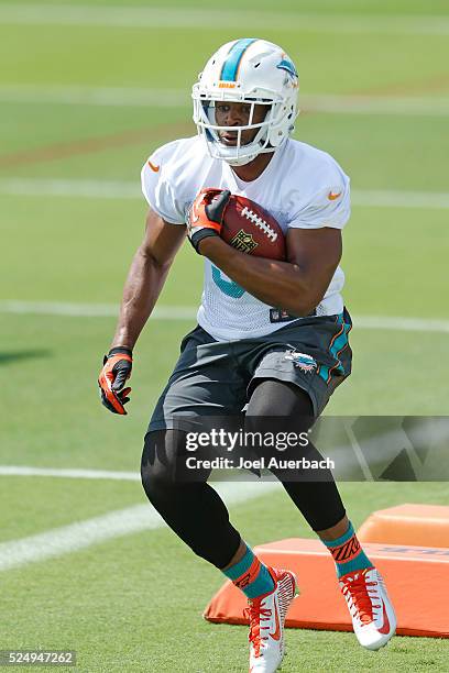 Daniel Thomas of the Miami Dolphins runs with the ball during the team's voluntary veterans minicamp on April 27, 2016 at the Miami Dolphins training...