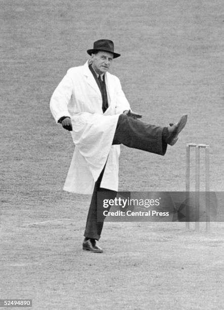 Cricket umpire Frank Chester taps his raised leg to signal a leg bye, July 1948.