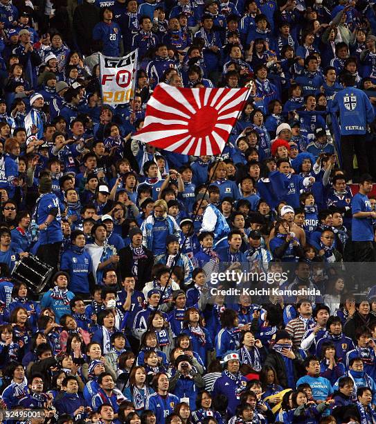 Japanese supporters wave a national flag during the 2006 FIFA World Cup Asian qualifying match between Japan and Bahrain at Saitama Stadium on March...