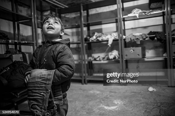 Alex, an impoverished child, receives new pants from Victory Outreach, a shelter and soup kitchen for the homeless in Bucharest. Photo: Jodi...