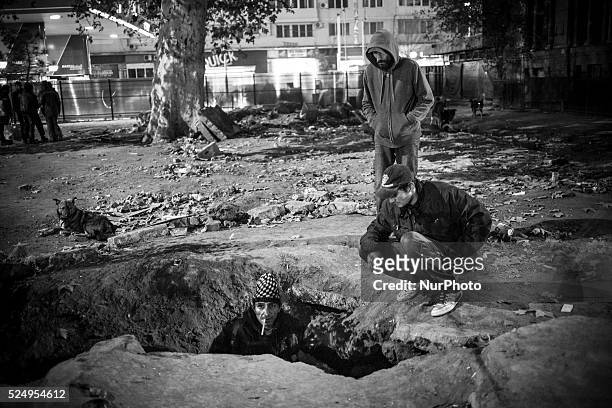 Drug users gather around the entrance to the underground sewage and heating system near Gara de Nord train station where many drug addicted and...