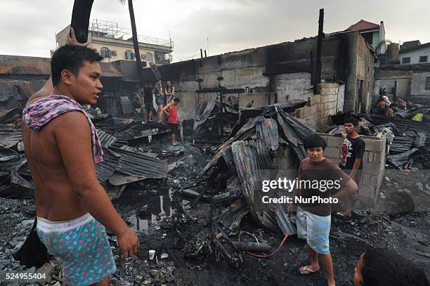 Philippines - Residents scavenge what's left of their house after a fire broke out, Wednesday morning and razed around 60 houses in a neighborhood in...