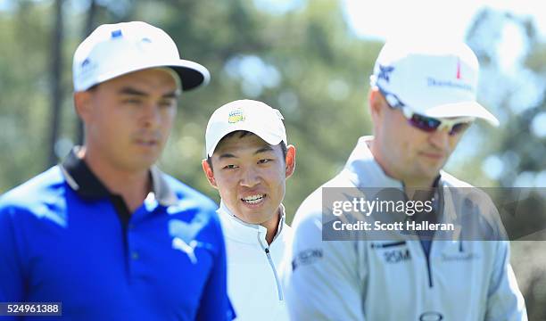 Amateur Cheng Lin of China walks with Rickie Fowler and Zach Johnson on the first hole during the second round of the 2016 Masters Tournament at the...