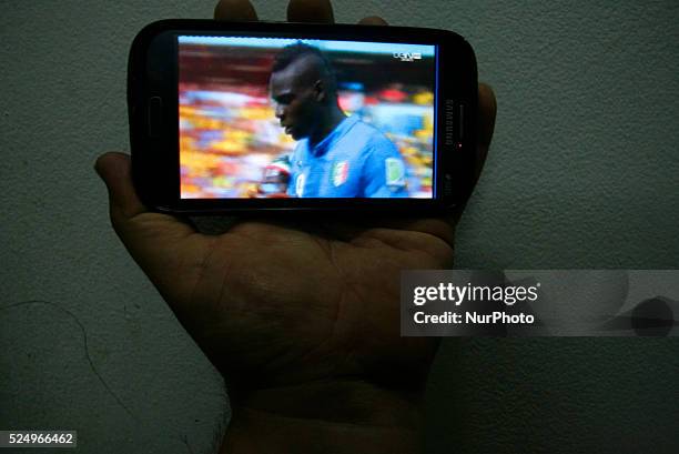 Palestinians watch a Group D match between Italy and Costa Rica of 2014 FIFA World Cup at the Arena Pernambuco Stadium in Recife, Brazil, in Rafah in...