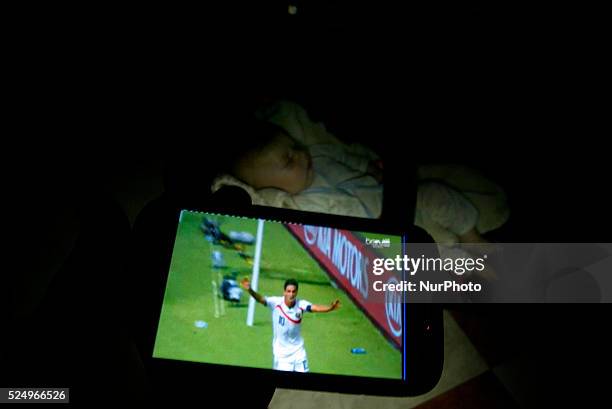 Palestinians watch a Group D match between Italy and Costa Rica of 2014 FIFA World Cup at the Arena Pernambuco Stadium in Recife, Brazil, in Rafah in...