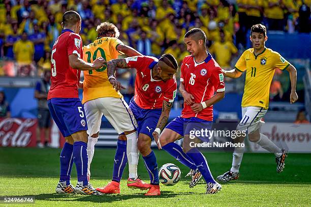 Neymar fights for the ball agains chilean players Vidal , Silva and Gutierrez at the match, for the Round of 16, of the 2014 World Cup, between...