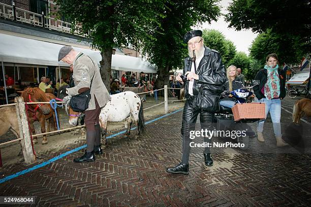 Horse dealers and their sticks used to keep the animals in place and calm. Every year on the 28th of July a horse market is held. The market...