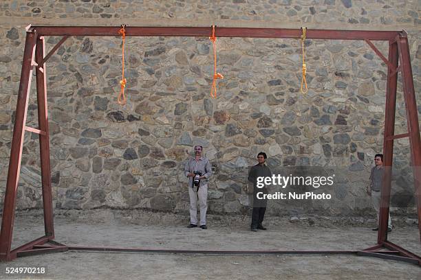 Nooses is prepared for men sentenced to death at a jail in Kabul, Afghanistan, Wednesday, Oct. 8, 2014. Afghan police take positions by nooses...