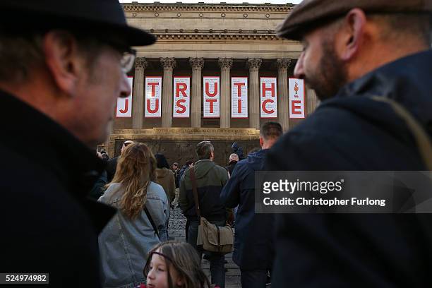 Thousands of people gather outside Liverpool's Saint George's Hall as they attend a vigil for the 96 victims of the Hillsborough tragedy on April 27,...