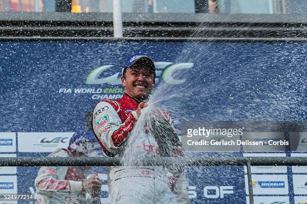 Class Audi Sport Team Joest Audi R18 e-tron quattro driver Marcel Fassler spraying champagne on the podium after winning the Round 2 of the FIA World...