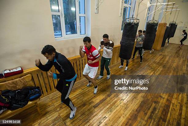 Students of High school of sport art in boxing circling in the gym, warming-up, Samarkand, Uzbekistan on 8 november 2104. High school of sport art in...