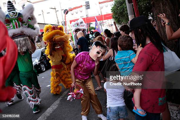 Woman with a Chinese mask performs in a street during the Chinese Lunar New Year celebration in the 'Liberdade' neighborhood in Sao Paulo, Brazil on...