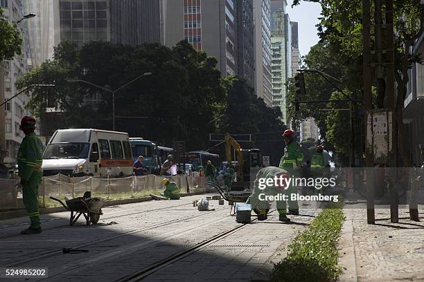 Workers build a light rail system in downtown Rio de Janeiro, Brazil, on Friday, April 15, 2016. The rail system will connect Rio's domestic airport...