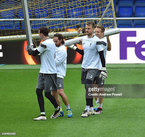 Danny Ward, Joe Allen, Simon Mignolet and Lucas Leiva of Liverpool help carry the goal during a training session at Estadio El Madrigal on April 27,...