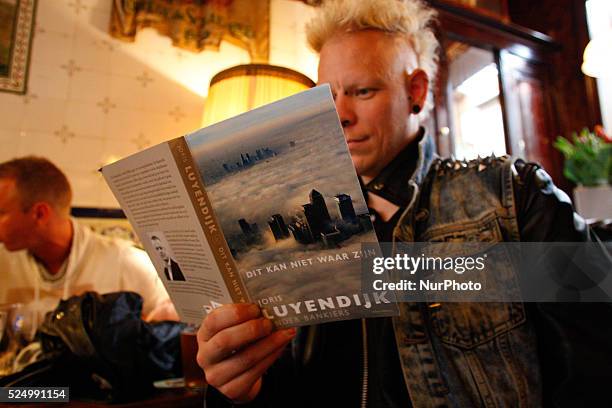 Man on April 30, 2015 in Leiden, Netherlands, is seen the recently released book by Dutch author Joris Luyendijk who spent three years interviewing...