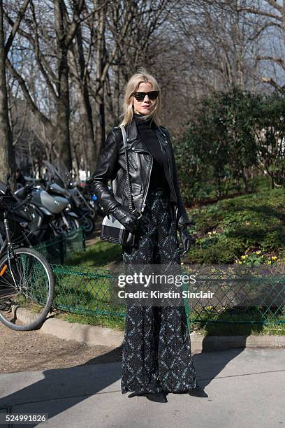Fashion Blogger Samantha Angelo wears RayBan sunglasses, Sergio Rossi shoes, Shrimpton Couture trousers, Schott jacket and Chanel Bag on day 7 during...