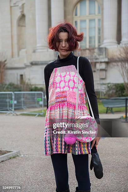 Model Shaked Aiach wears a Liron Itzhakov dress anf bag, Dr Martens boots on day 7 during Paris Fashion Week Autumn/Winter 2016/17 on March 7, 2016...