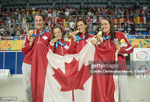 The Canadian women's 4 x 100 meter freestyle team of Chantal Van Landeghem, Katerine Savard, Michelle Williams, and Sandrine Mainville celebrate...