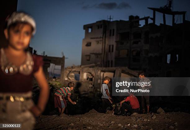 Palestinian children play next to buildings destroyed during the 50-day conflict between Hamas militants and Israel, in Shejaiya neighbourhood in the...