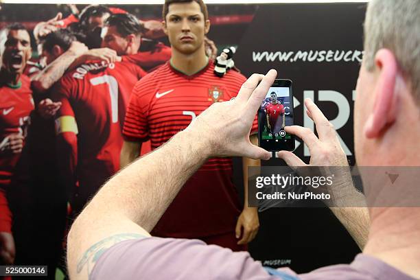 Fan take a picture of the Cristiano Ronaldo waxwork on display at the Cristiano Ronaldo traveling museum in Lisbon, on October 6, 2015.