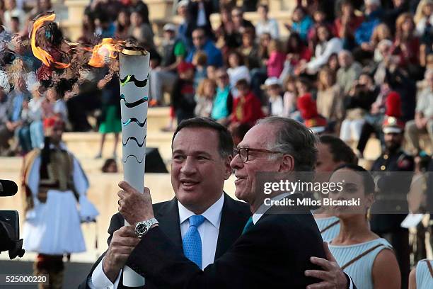 Carlos Nuzman, president of the Rio 2016 organizing committee receives the Olympic Flame from the head of Greece's Olympic Committee, Spyros...