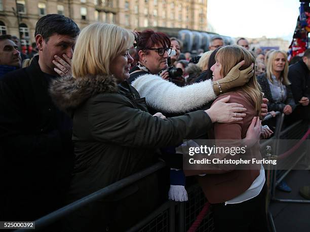 Margaret Aspinall is hugged by members of the public as thousands gather outside Liverpool's Saint George's Hall as they attend a vigil for the 96...