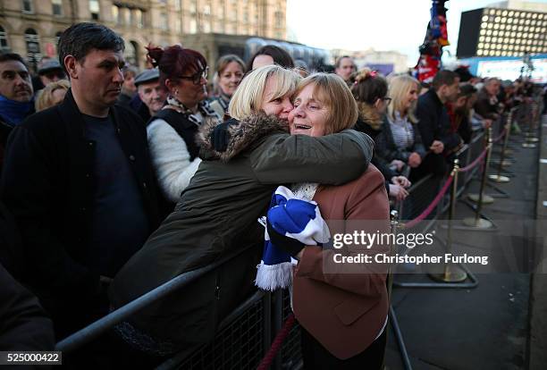 Margaret Aspinall is hugged by members of the public as thousands gather outside Liverpool's Saint George's Hall as they attend a vigil for the 96...