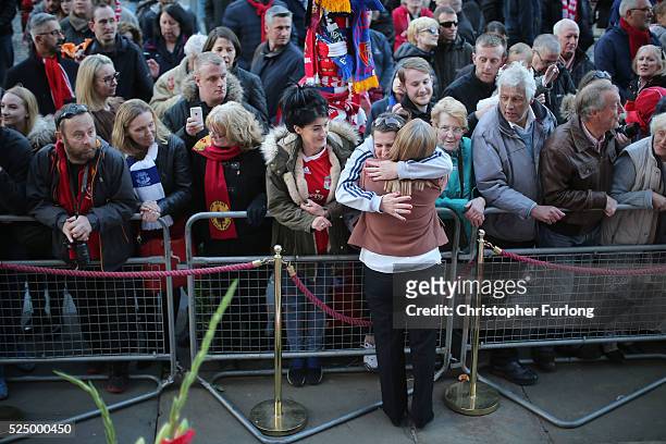 Margaret Aspinall is hugged by members of the public as thousands gather outside Liverpool's Saint George's Hall as they attend a vigil for the 96...