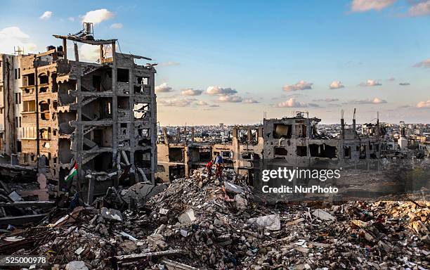 Palestinian man walks over a building destroyed during the 50-day conflict between Hamas militants and Israel, in Shejaiya neighbourhood in the east...