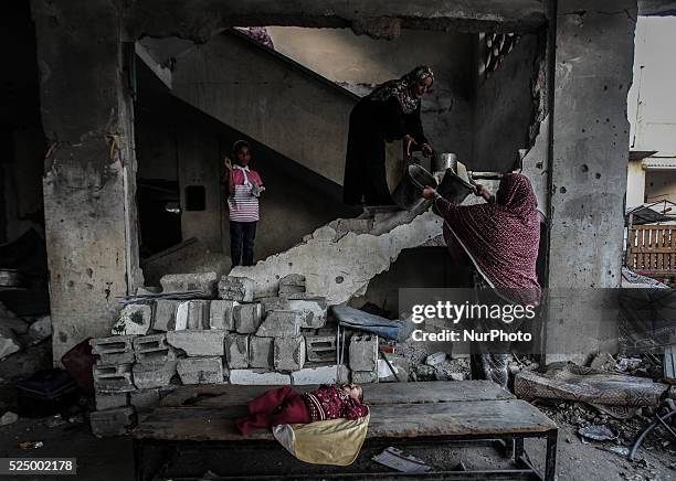 Palestinian woman stands in his home destroyed during the 50-day conflict between Hamas militants and Israel, in Shejaiya neighbourhood in the east...