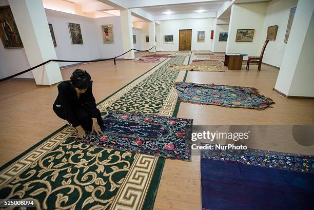 Museum manager chooses suzani, traditional Uzbek embroidery textile, for the exhibition in new building of Samarkand State Memorial Museum,...