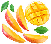 Slices of mango fruit and leaves over white.