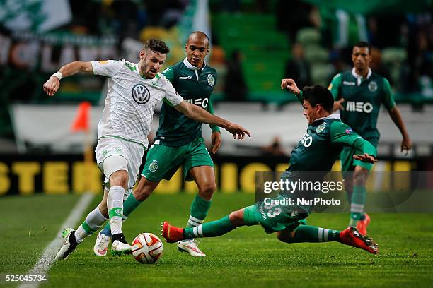 Sporting's defender Jonathan Silva vies for the ball with Wolfsburg's midfielder Daniel Caligiuri during the UEFA Europa League football match...