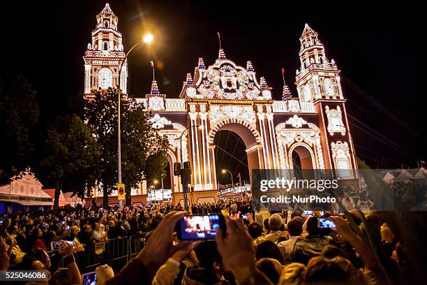 People takes photographs at the moment when the main entrance of the &quot;Feria de Abril&quot; is enlightened, Seville, Spain, 21 april, 2015.