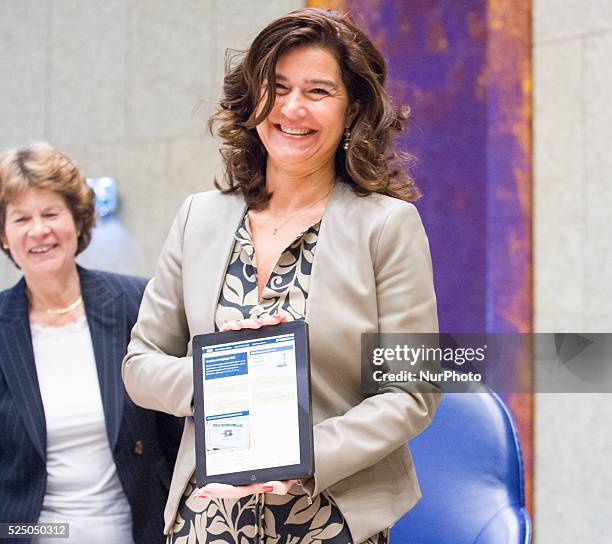 The President of the House of Representatives Anouchka van Miltenburg is seen with an electronic version of the yearly accounting report handed over...