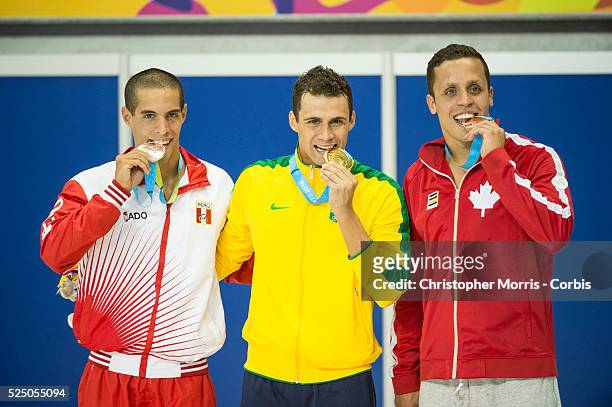 Mauricio Fiol, of Peru , Leonardo De Deus, of Brazil and Zach Chetrat, of Canada during the medal ceremony for the men's 200 meter butterfly during...