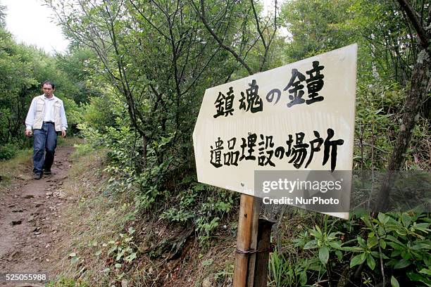 Relatives of the victims of the 1985 Japan Airlines jumbo jet crash pray in front of the victims' monument at Osutaka Ridge north of Tokyo, Japan,...