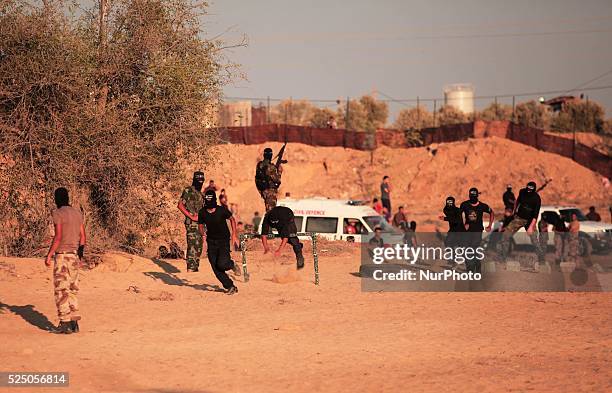 Palestinian militants from the Mujahideen Brigades demonstrate their skills at a scene simulating an attack on an Israeli site during a military...