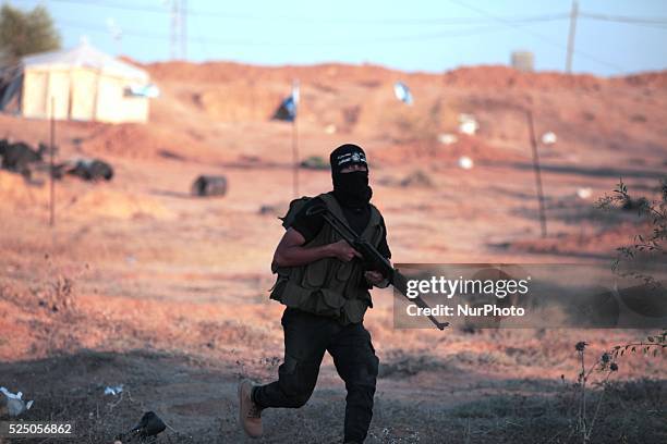 Palestinian militants from the Mujahideen Brigades demonstrate their skills at a scene simulating an attack on an Israeli site during a military...