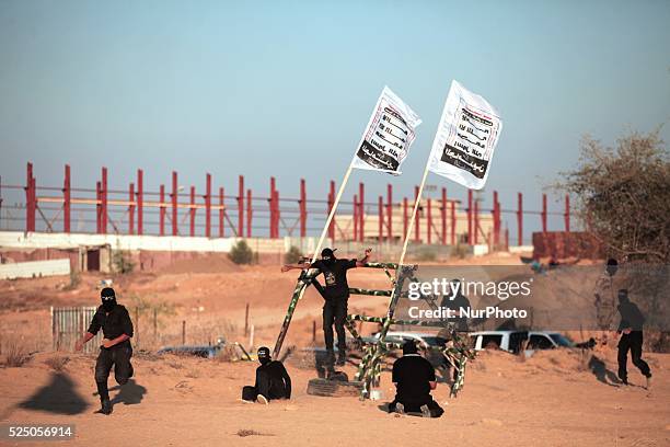 Palestinian militants from the Mujahideen Brigades demonstrate their skills at a scene simulating an attack on an Israeli site during a military...