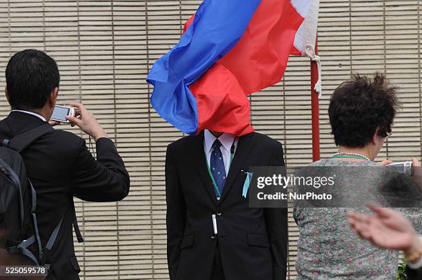 Philippines - The face of a Japanese is accidentally covered by the Philippine flag as relatives of the fallen japanese soliders of WW2 have their...